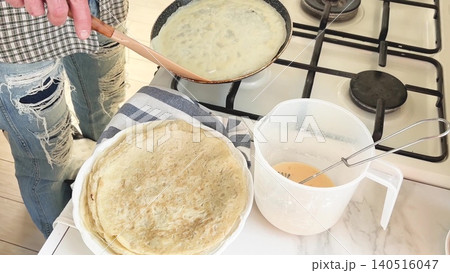 Mans hands flip a thin pancake. Closeup Mans hands flip a thin pancake. Closeup 140516047