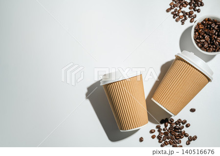 Roasted Coffee Beans and Takeaway Coffee Cups with on Light Background and soft shadows. Copy space Roasted Coffee Beans and Takeaway Coffee Cups with on Light Background and soft shadows. Copy space 140516676