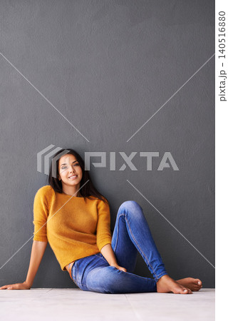 Portrait, girl and relax or chill on floor with casual outfit for fashion or comfort, leisure and wellness with smile. Female person, isolated with grey background or wall for clothing with mockup. Portrait, girl and relax or chill on floor with casual outfit for fashion or comfort, leisure and wellness with smile. Female person, isolated with grey background or wall for clothing with mockup. 140516880