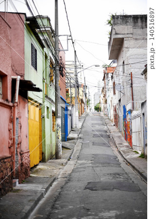Houses, barrio and street in city with architecture, color and slum with buildings on urban road. Neighborhood, favela and apartment with expansion, home and ghetto housing project in Sao Paulo Houses, barrio and street in city with architecture, color and slum with buildings on urban road. Neighborhood, favela and apartment with expansion, home and ghetto housing project in Sao Paulo 140516897