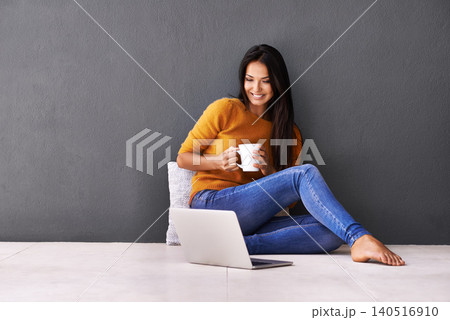 Laptop, search and happy woman on a floor with coffee for streaming, reading or movie on wall background. Computer, mockup or female person online for chill app sign up 140516910