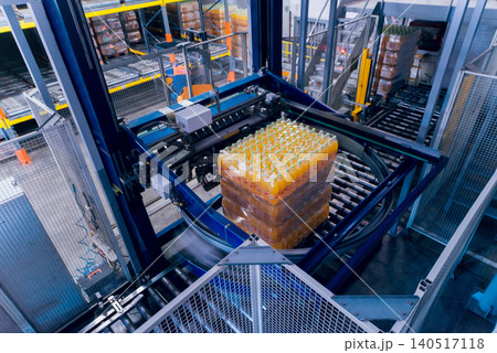 Strapping machine for packaging line. Modern machine for packaging line in factory. Technology and industrial concept. Strapping machine for packaging line. Modern machine for packaging line in factory. Technology and industrial concept. 140517118