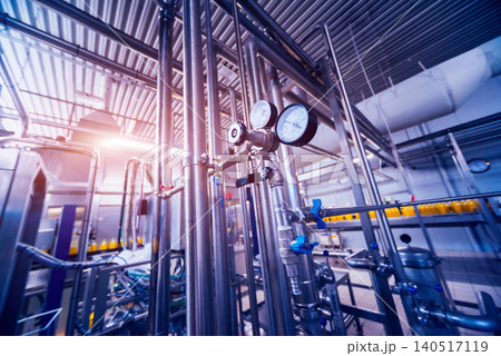 Modern interior of a brewery. Barrels and pipes. Factory interior. Modern interior of a brewery. Barrels and pipes. Factory interior. 140517119