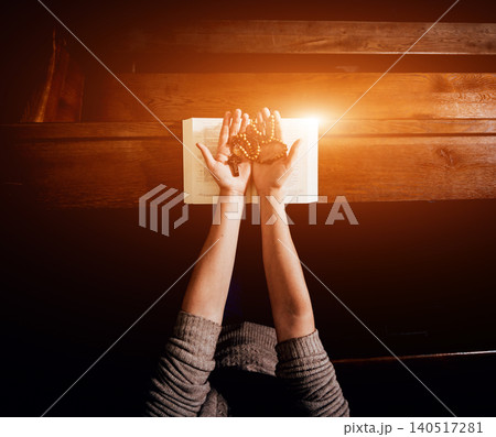 Christian woman praying in church. Hands crossed and Holy Bible on wooden desk. Christian woman praying in church. Hands crossed and Holy Bible on wooden desk. 140517281