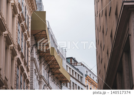 Suspended facade scaffolding on historic building - urban renovation in European city Suspended facade scaffolding on historic building - urban renovation in European city 140517374