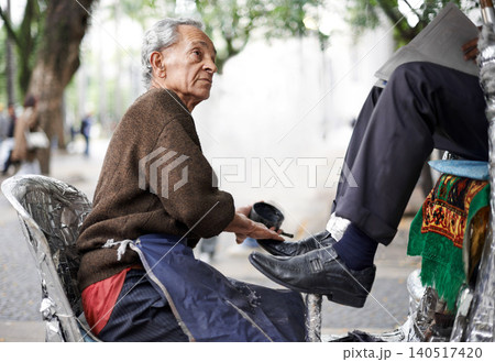 Shine, shoes or old man in city, street or cleaning service for client or customer with polish, trade or job. Chair, senior or feet of businessman in downtown Sao Paulo for footwear or outdoor help Shine, shoes or old man in city, street or cleaning service for client or customer with polish, trade or job. Chair, senior or feet of businessman in downtown Sao Paulo for footwear or outdoor help 140517420
