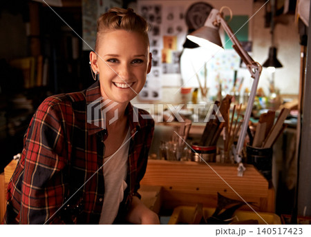 Artist, workshop and portrait of happy woman in studio to work on creative sculpture or project at night. Artisan, workplace or person with pride or confidence as carpenter with talent and tools 140517423