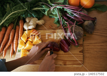 Closeup, kitchen and hands with woman, vegetables and chopping board with knife, home and diet plan. Person, vegan and chef with food or ingredients for lunch and supper with healthy meal or wellness Closeup, kitchen and hands with woman, vegetables and chopping board with knife, home and diet plan. Person, vegan and chef with food or ingredients for lunch and supper with healthy meal or wellness 140517502