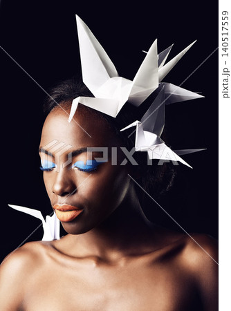 Black woman, fine art and blue eyeshadow with beauty, dove or origami birds on a dark studio background. Closeup or face of African female person or model with makeup or cosmetics on mockup space Black woman, fine art and blue eyeshadow with beauty, dove or origami birds on a dark studio background. Closeup or face of African female person or model with makeup or cosmetics on mockup space 140517559