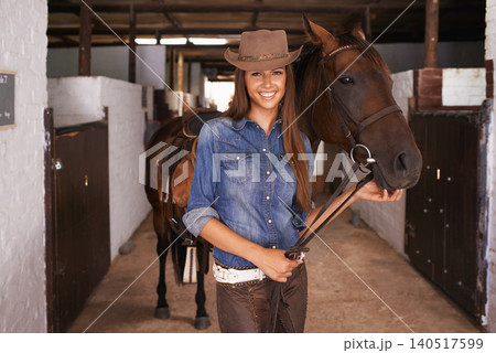 Cowgirl, portrait and happy woman with horse at barn or stable in Texas for recreation. Western hat, person and animal at ranch with pet, livestock or stallion for hobby with care at equestrian farm 140517599