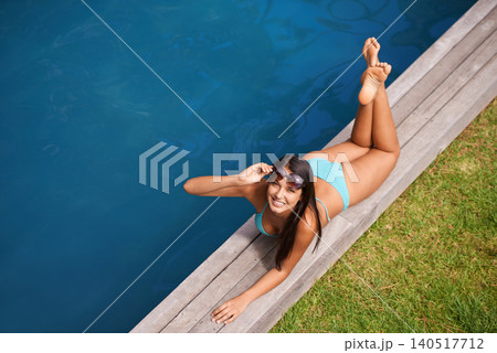Portrait of woman, bikini or tan at swimming pool to relax or chill in summer holiday vacation in Hawaii. Smile, break or happy female person sunbathing in swimwear at resort, home or hotel for peace 140517712