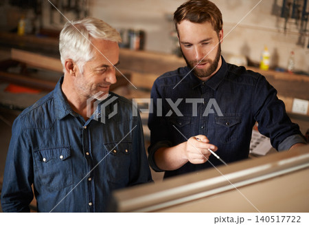 Brainstorming, discussion and architects by board in workshop for industrial carpentry project. Planning, engineering and male industry apprentice working on ideas with mentor in office on site. 140517722