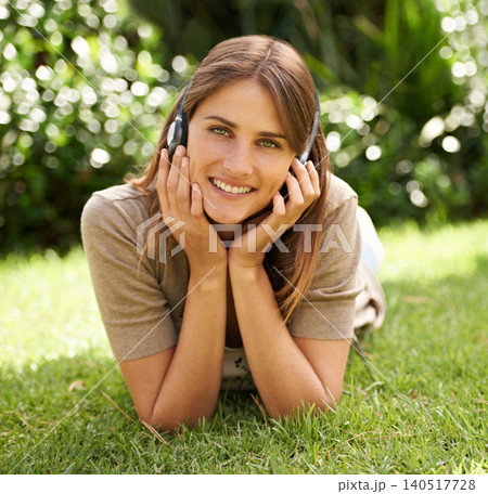 Portrait, headphones and woman relax on grass, field and nature in garden, backyard and pasture listening to music in summer. Female person, gen z girl and smile on lawn, grassland and warm weather Portrait, headphones and woman relax on grass, field and nature in garden, backyard and pasture listening to music in summer. Female person, gen z girl and smile on lawn, grassland and warm weather 140517728