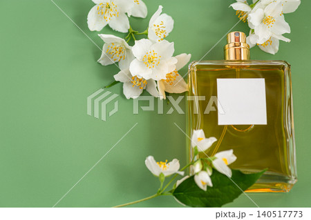 elegant fragrance bottle surrounded by white jasmine blossoms elegant fragrance bottle surrounded by white jasmine blossoms 140517773