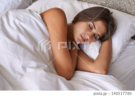 Woman, wellness and sleeping in bed at home, health and peace rest on soft pillow on comfortable mattress. Tired person, dream or relax in bedroom for stress relief, fatigue or weekend in cozy house 140517780