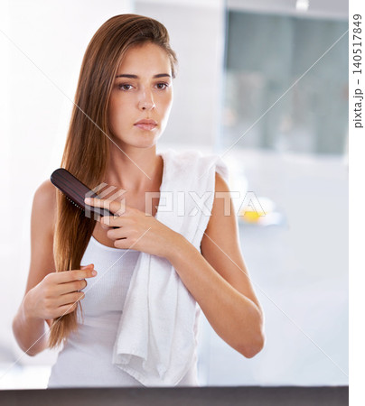 Reflection, woman and brush hair in bathroom at home for beauty, care or morning routine with cosmetics. Mirror, hairstyle and serious person combing for cleaning, hygiene or treatment for wellness Reflection, woman and brush hair in bathroom at home for beauty, care or morning routine with cosmetics. Mirror, hairstyle and serious person combing for cleaning, hygiene or treatment for wellness 140517849