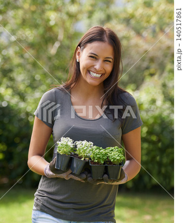 Happy woman, flowers and gardening with portrait in nature, ecology and sustainability with environment. Landscaping, gardener with plant and eco friendly for growth, greenery and botanical outdoor 140517861