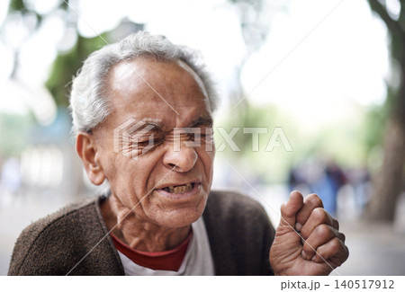 Face, sick and old man sneezing in a street or city in retirement, neighborhood and town. Sao Paulo, flu illness and elderly male person with hay fever, hardship and wisdom in outdoor area and Brazil 140517912