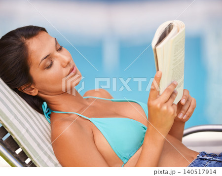 Woman, bikini and swimming pool relax or reading book for holiday vacation at hotel accommodation, summer or resting. Female person, swimwear and Hawaii trip for travel resort, tanning or peaceful 140517914