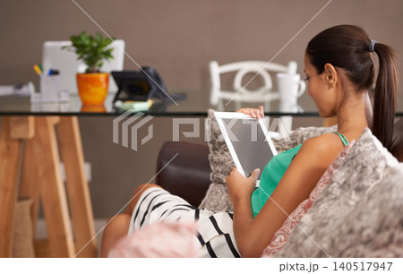 Tablet, screen and woman on a sofa with social media, scroll or reading ebook at home. Digital, space or female person in a living room with streaming movie app search, entertainment and chill Tablet, screen and woman on a sofa with social media, scroll or reading ebook at home. Digital, space or female person in a living room with streaming movie app search, entertainment and chill 140517947