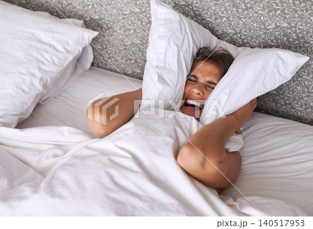 Woman, noise or insomnia in bedroom to rest, tired or cover ears with pillow for crisis of loud background. Lady, frustrated and mad for sound or sleep problem, anxiety and headache or stress in home Woman, noise or insomnia in bedroom to rest, tired or cover ears with pillow for crisis of loud background. Lady, frustrated and mad for sound or sleep problem, anxiety and headache or stress in home 140517953