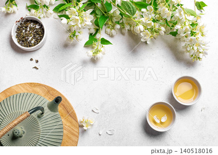 Green jasmine tea and flowers Green jasmine tea and flowers 140518016