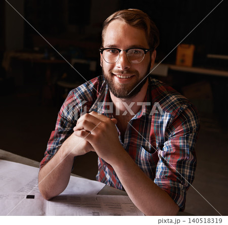 Portrait, man and architect with documents in workshop on wooden table for paperwork of startup. Confident, entrepreneur and male person with smile for small business in industry for construction Portrait, man and architect with documents in workshop on wooden table for paperwork of startup. Confident, entrepreneur and male person with smile for small business in industry for construction 140518319