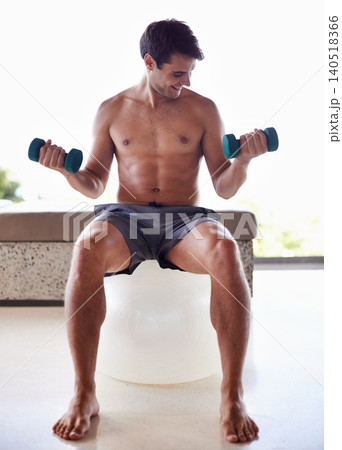 Man, exercise ball and dumbbells for weightlifting, fitness and muscle training for body and self care. Topless athlete, smile and endurance in workout at home for health, wellness and strength Man, exercise ball and dumbbells for weightlifting, fitness and muscle training for body and self care. Topless athlete, smile and endurance in workout at home for health, wellness and strength 140518366