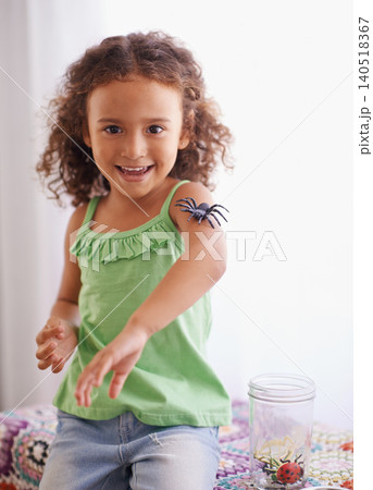 Portrait, child and toys in room for development, curiosity and growth with insect jar. Happiness, animal and face of young girl playing in kindergarten for learning, discovery or education. Portrait, child and toys in room for development, curiosity and growth with insect jar. Happiness, animal and face of young girl playing in kindergarten for learning, discovery or education. 140518367