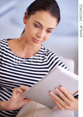 Woman, tablet and reading connection on couch in apartment for movie streaming with technology, communication or social media. Female person, browsing and sofa in home for web, internet or download 140518422