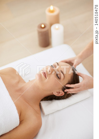 Relax, head massage and woman at spa for health, wellness and zen with luxury holistic treatment. Self care, peace and girl on bed for aromatherapy, comfort and calm pamper service at hotel salon 140518478