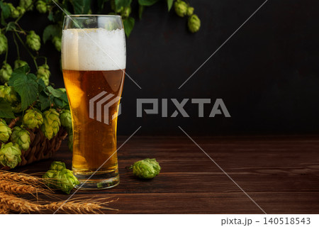 Glass of beer with foam, hops, and wheat Glass of beer with foam, hops, and wheat 140518543