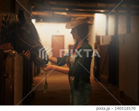 Cowgirl, smile and woman with horse at stable or barn in Texas for recreation. Western, animal and happy person at a ranch with pet, friendship and stallion for hobby with care at equestrian farm Cowgirl, smile and woman with horse at stable or barn in Texas for recreation. Western, animal and happy person at a ranch with pet, friendship and stallion for hobby with care at equestrian farm 140518570