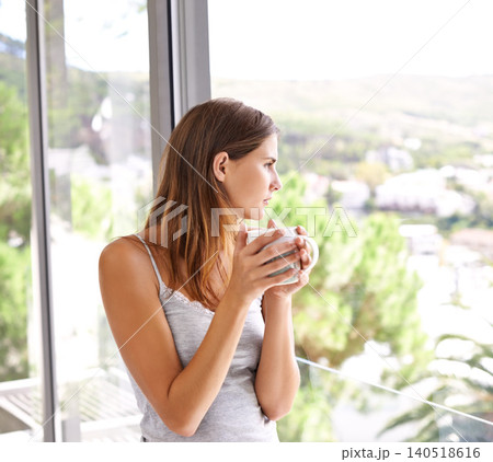 Coffee, woman and relax on balcony with view, weekend and espresso cup for morning inspiration. Young lady, thinking or peace with cocoa for comfort, mindfulness or calm on break in modern apartment Coffee, woman and relax on balcony with view, weekend and espresso cup for morning inspiration. Young lady, thinking or peace with cocoa for comfort, mindfulness or calm on break in modern apartment 140518616