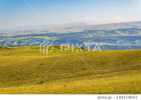 Layers of green mountains and hills in the haze during sunset. Panoramic View of Green hills and Meadow. Layers of green mountains and hills in the haze during sunset. Panoramic View of Green hills and Meadow. 140518691