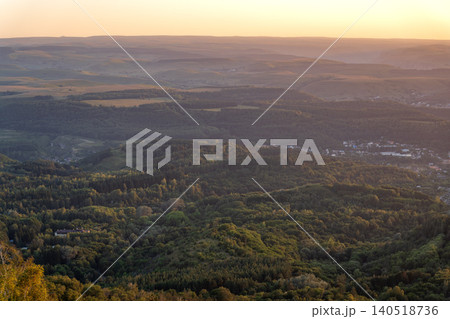 Layers of green mountains and hills in the haze during sunset. Panoramic View of Green hills and Meadow. Layers of green mountains and hills in the haze during sunset. Panoramic View of Green hills and Meadow. 140518736