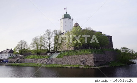 Historic Tower By Tranquil River. Serene Waterside Scene Featuring Ancient Castle And Rising Tower. Creative 140519120