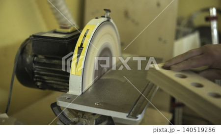 Polishing Drilled Holes. Artisan Uses Abrasive Sanding To Refine And Smooth Drilled Wooden Surface. Media Polishing Drilled Holes. Artisan Uses Abrasive Sanding To Refine And Smooth Drilled Wooden Surface. Media 140519286
