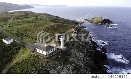 Cliffside Lighthouse Bathed In Morning Glow. Vantage Of Towering Lighthouse Overlooking Stormy Ocean. Media Cliffside Lighthouse Bathed In Morning Glow. Vantage Of Towering Lighthouse Overlooking Stormy Ocean. Media 140519335