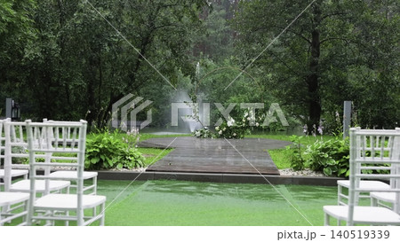 Serene Garden Ceremony Setting. Intimate Wedding Scene With Natural Beauty And Gentle Lighting. Creative Serene Garden Ceremony Setting. Intimate Wedding Scene With Natural Beauty And Gentle Lighting. Creative 140519339