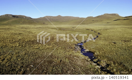 Unmanned Aerial Perspective Highlighting Flowing Stream Amid Expansive Natural Wilderness Landscapes. Media Unmanned Aerial Perspective Highlighting Flowing Stream Amid Expansive Natural Wilderness Landscapes. Media 140519341