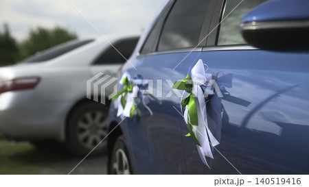 Car Door Decorated With Bow At Rural Event. Serene Scene With Decorated Vehicle And Blurred Background . Media Car Door Decorated With Bow At Rural Event. Serene Scene With Decorated Vehicle And Blurred Background . Media 140519416