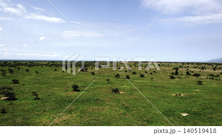 Elevated Observation Capturing Expansive Green Plain Dotted With Varied Hills Under Clear Blue Sky. Media Elevated Observation Capturing Expansive Green Plain Dotted With Varied Hills Under Clear Blue Sky. Media 140519418