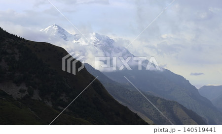 Summit Rising Through Misty Skies, Peaked Summit Piercing Through Fog With Verdant Valley Below. Creative 140519441