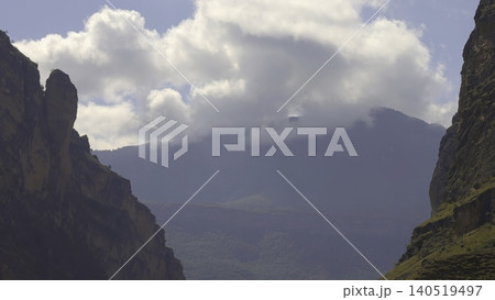 Mountain Road Journey, Dynamic Depiction Of Vehicles Navigating Winding Mountain Pass With Sunlight And Clouds. Creative Mountain Road Journey, Dynamic Depiction Of Vehicles Navigating Winding Mountain Pass With Sunlight And Clouds. Creative 140519497