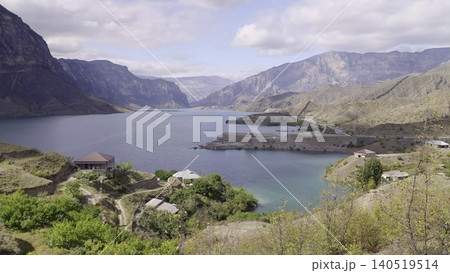 Serene Mountain Valley With Cabins. Media. Quiet Mountain Inlet Surrounded By Towering Peaks And Gentle Water 140519514