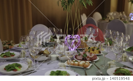 Sumptuous Event Space Showcasing Gleaming Glasses Complemented By Vibrant Green Accents Above Tables. Creative Sumptuous Event Space Showcasing Gleaming Glasses Complemented By Vibrant Green Accents Above Tables. Creative 140519548