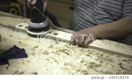 Experienced Technician Precisely Calibrates Pressure During Extensive Wood Polishing Tasks. Media Experienced Technician Precisely Calibrates Pressure During Extensive Wood Polishing Tasks. Media 140519579
