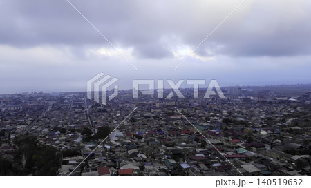 Cloudy Cityscape Overview. Overhead Image Capturing Congested Rooftops Near Stormy Sky And Distant Sea. Media 140519632