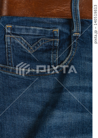 Closeup of denim jeans with pocket and belt showing fabric texture Closeup of denim jeans with pocket and belt showing fabric texture 140519813